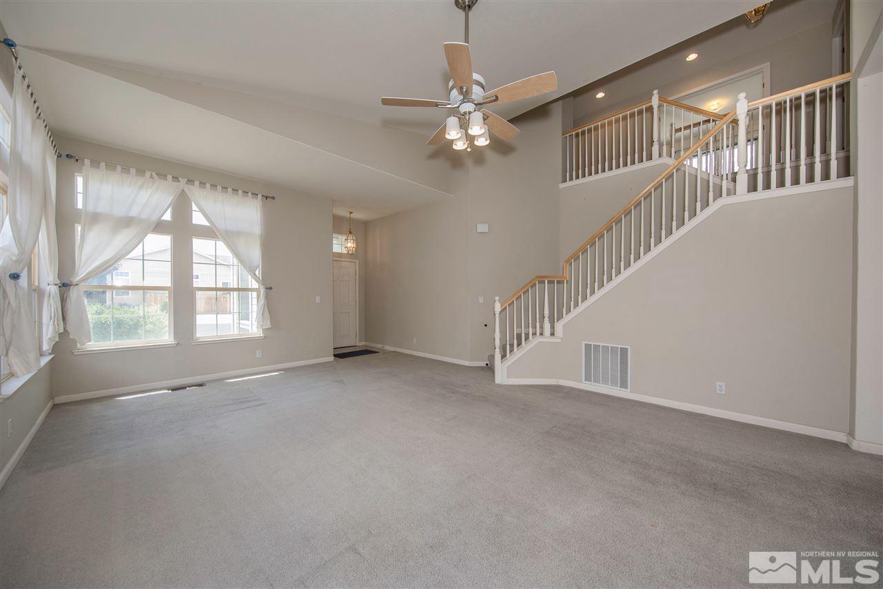 9910 Rock River Drive Reno, NV 89506 - Photo 3 of 24 a view of an empty room with wooden floor and a window