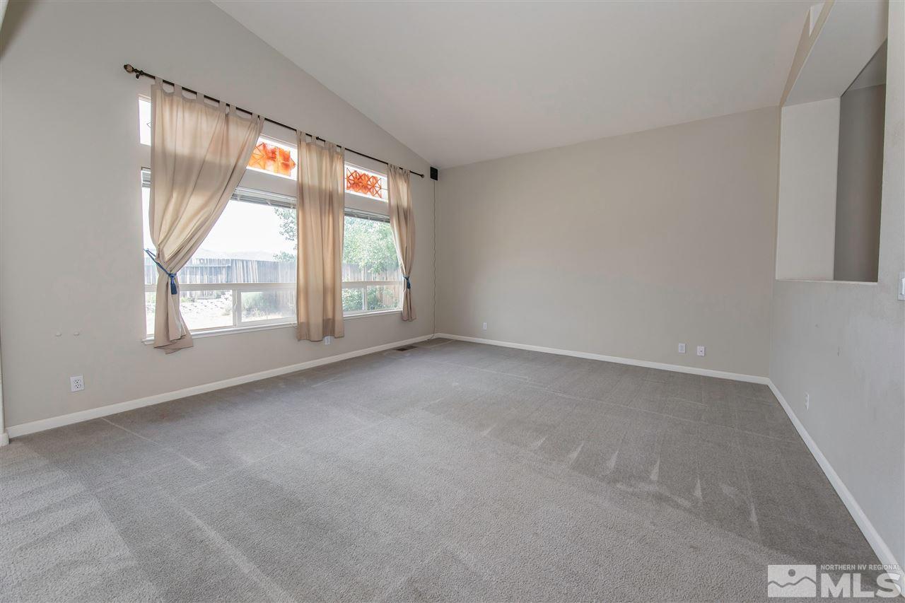 9910 Rock River Drive Reno, NV 89506 - Photo 7 of 24 an empty room with windows and city view