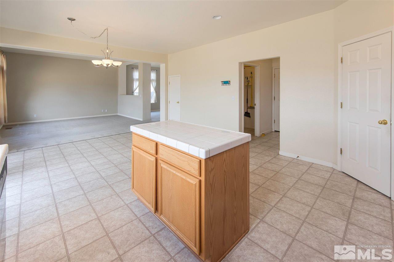 9910 Rock River Drive Reno, NV 89506 - Photo 9 of 24 a kitchen with stainless steel appliances a sink and cabinets