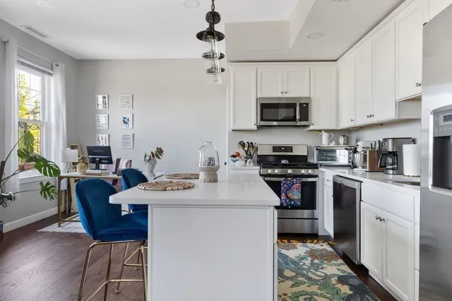 a kitchen with a sink stove and microwave