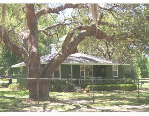 39346 Mercer Road Dade City, FL 33523 - Photo 1 of 1 a front view of a house with a yard