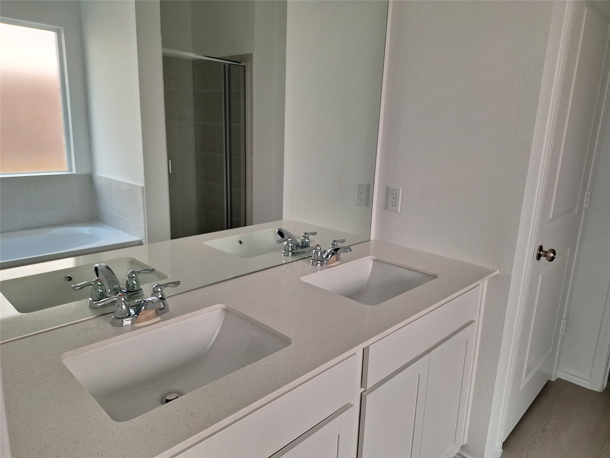 18001 Prairie Falcon Way Pflugerville, TX 78660 - Photo 3 of 38 Dual vanity with white cabinetry and integrated sinks set in a light-colored countertop