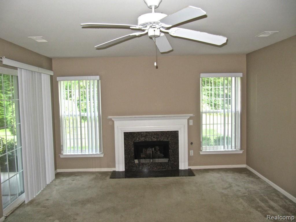 3397 Tremonte Circle, Unit 202 Rochester, MI 48306 - Photo 13 of 35 Great Room with fireplace and access to patio