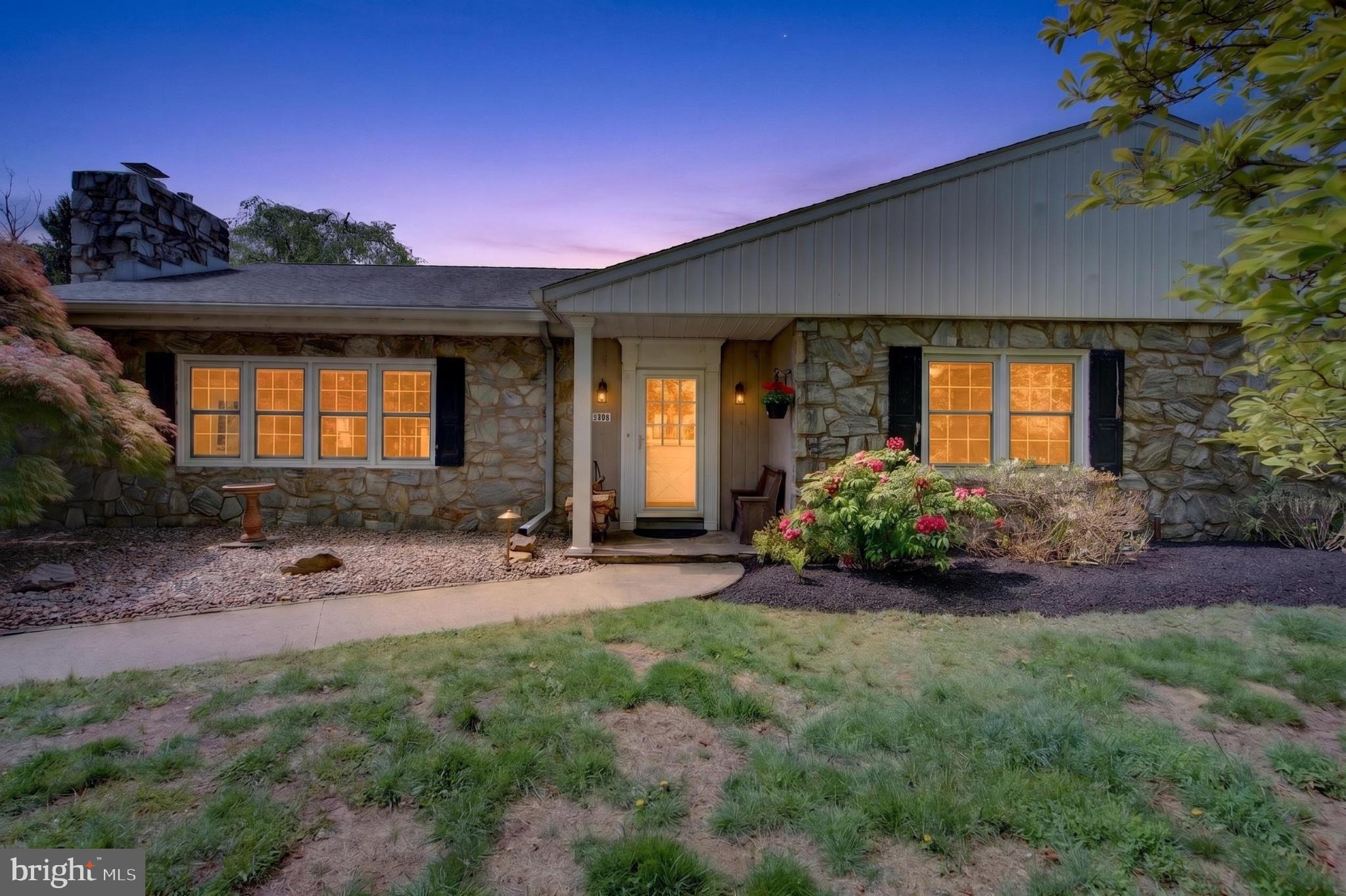 Charming stone home at twilight glow.