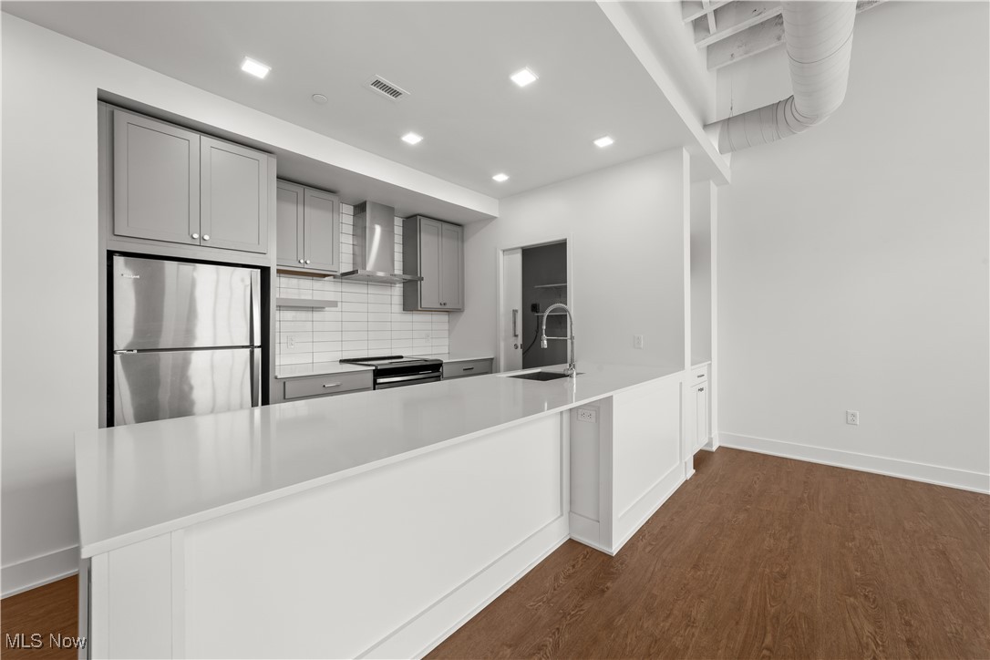 2048 Fulton Road, Unit 107 Cleveland, OH 44113 - Photo 26 of 37 Kitchen with stainless steel appliances and large island with space for 3 to 4 counter stools