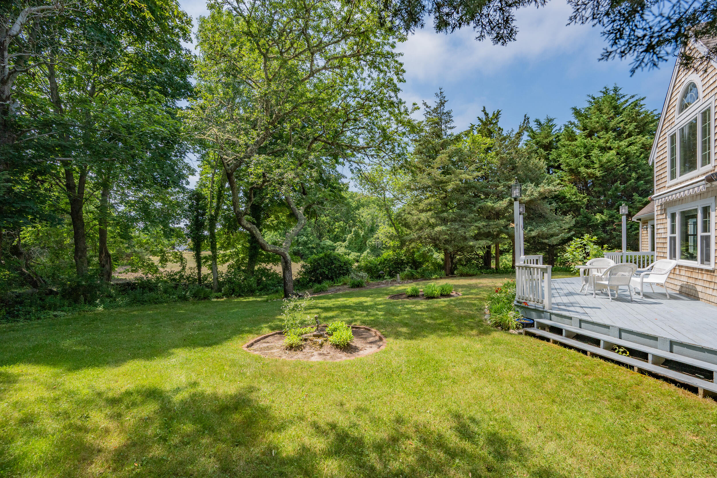 4323 Main Street Barnstable, MA 02630 - Photo 5 of 33 a view of a wooden deck with a big yard