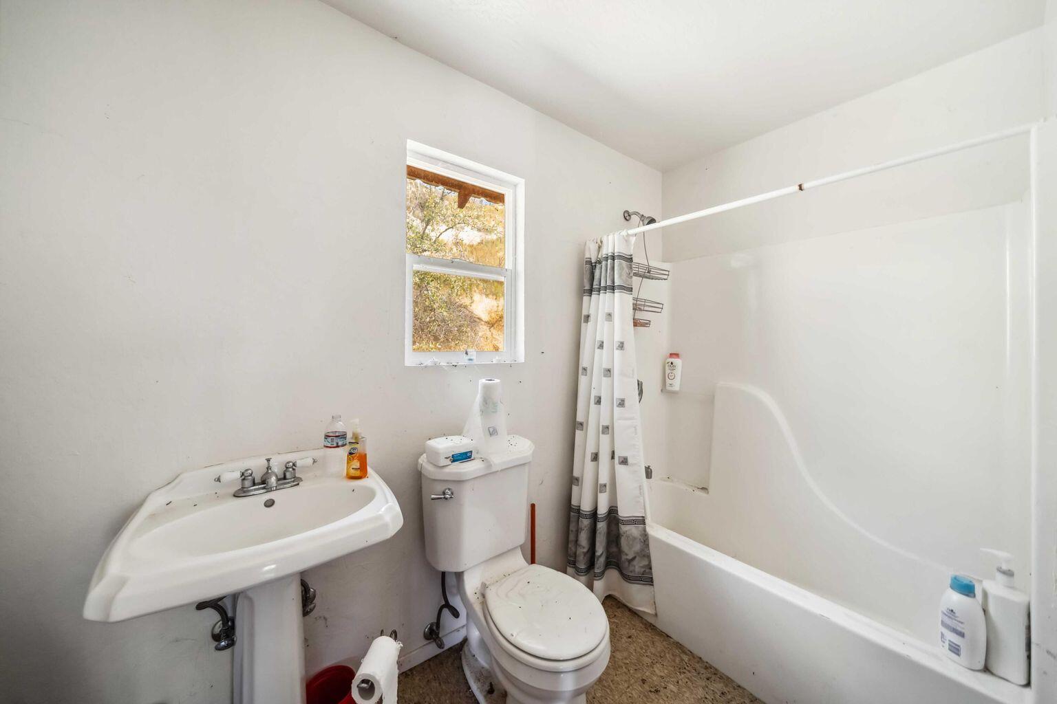 0 Vestal Road Platina, CA 96076 - Photo 17 of 34 a white toilet sitting next to a white bath tub sitting next to a white sink and a shower