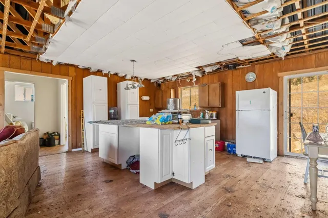 a kitchen with refrigerator and cabinets