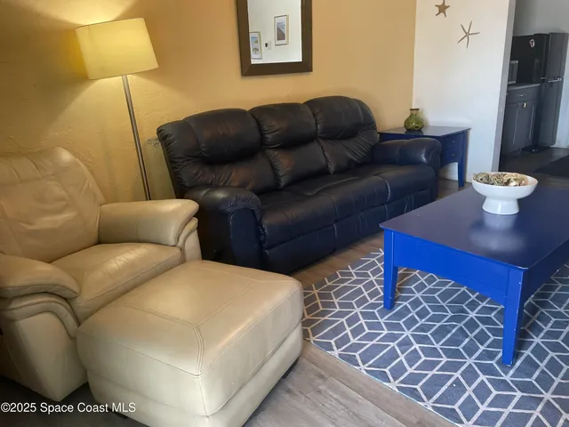 a living room with furniture and a lamp
