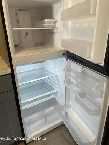 a living room with furniture a rug and a floor to ceiling window