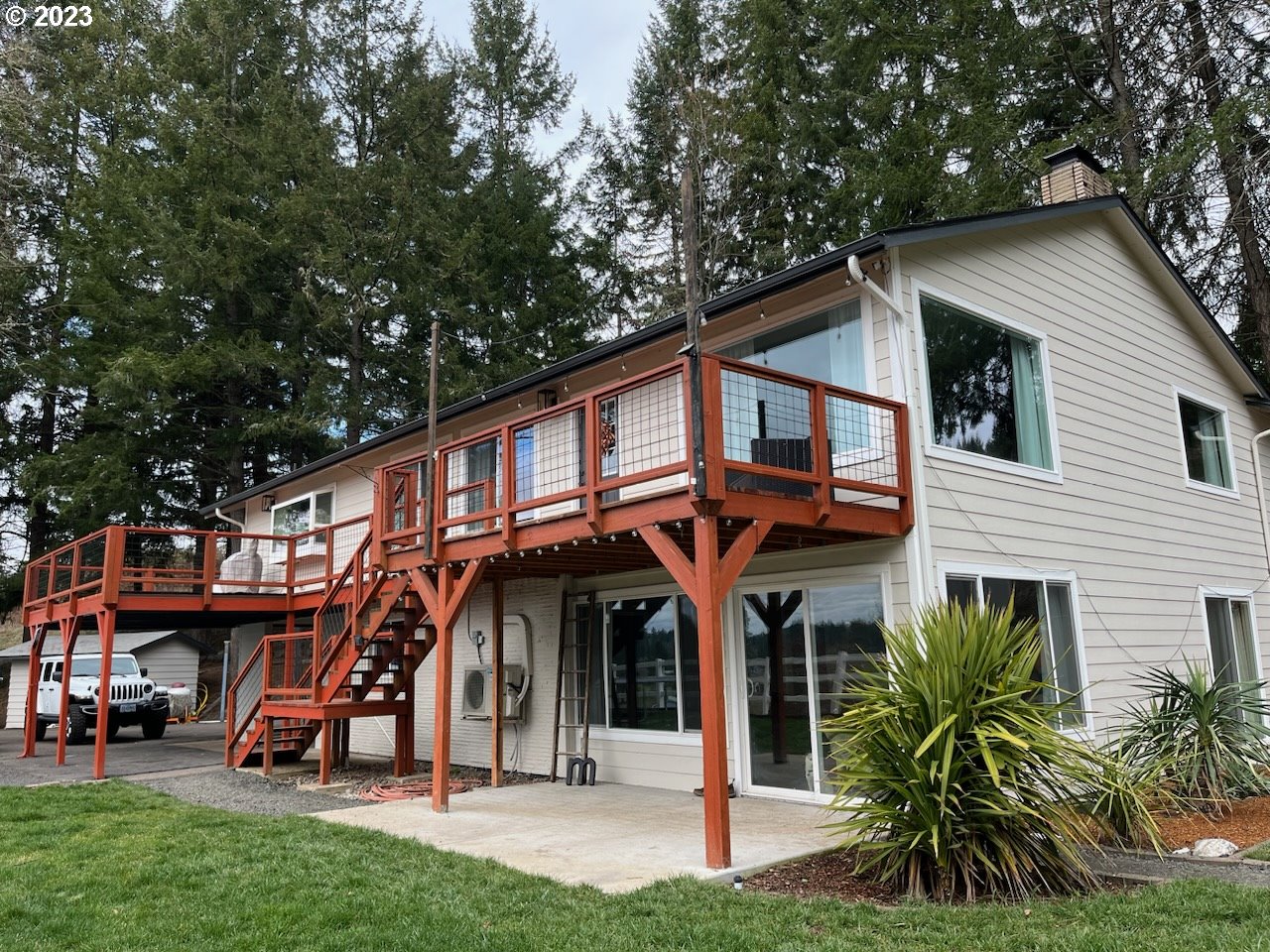 85903 Bailey Hill Road Eugene, OR 97405 - Photo 1 of 27 a view of a house with a small yard and a large tree