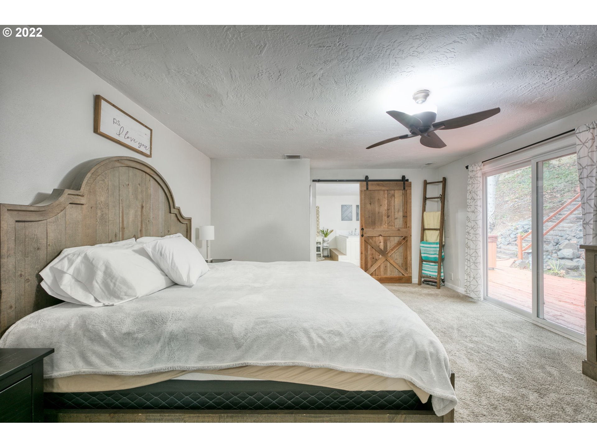 85903 Bailey Hill Road Eugene, OR 97405 - Photo 15 of 27 a bedroom with a large bed and a large window