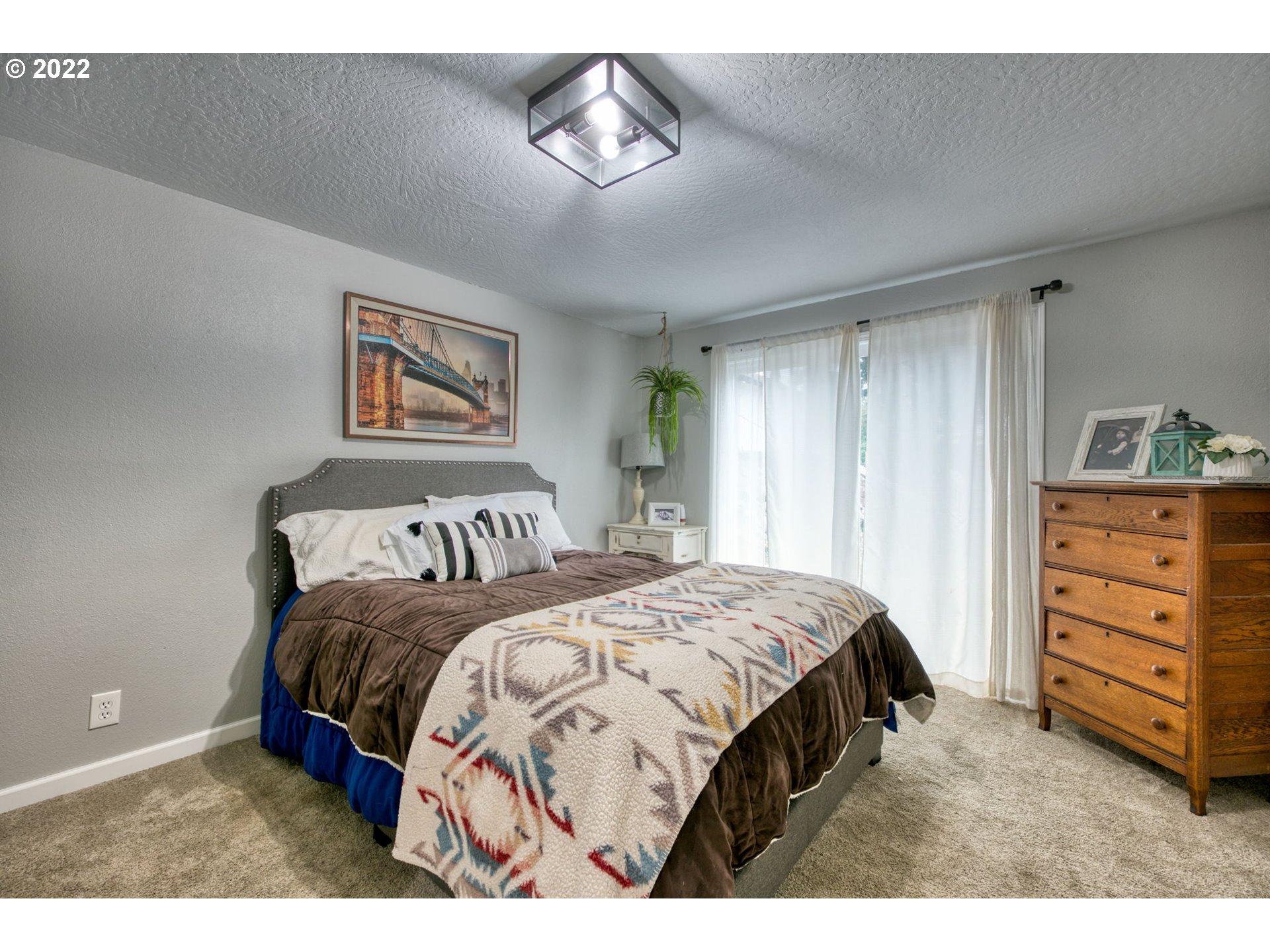 85903 Bailey Hill Road Eugene, OR 97405 - Photo 21 of 27 a bedroom with a bed and a chandelier