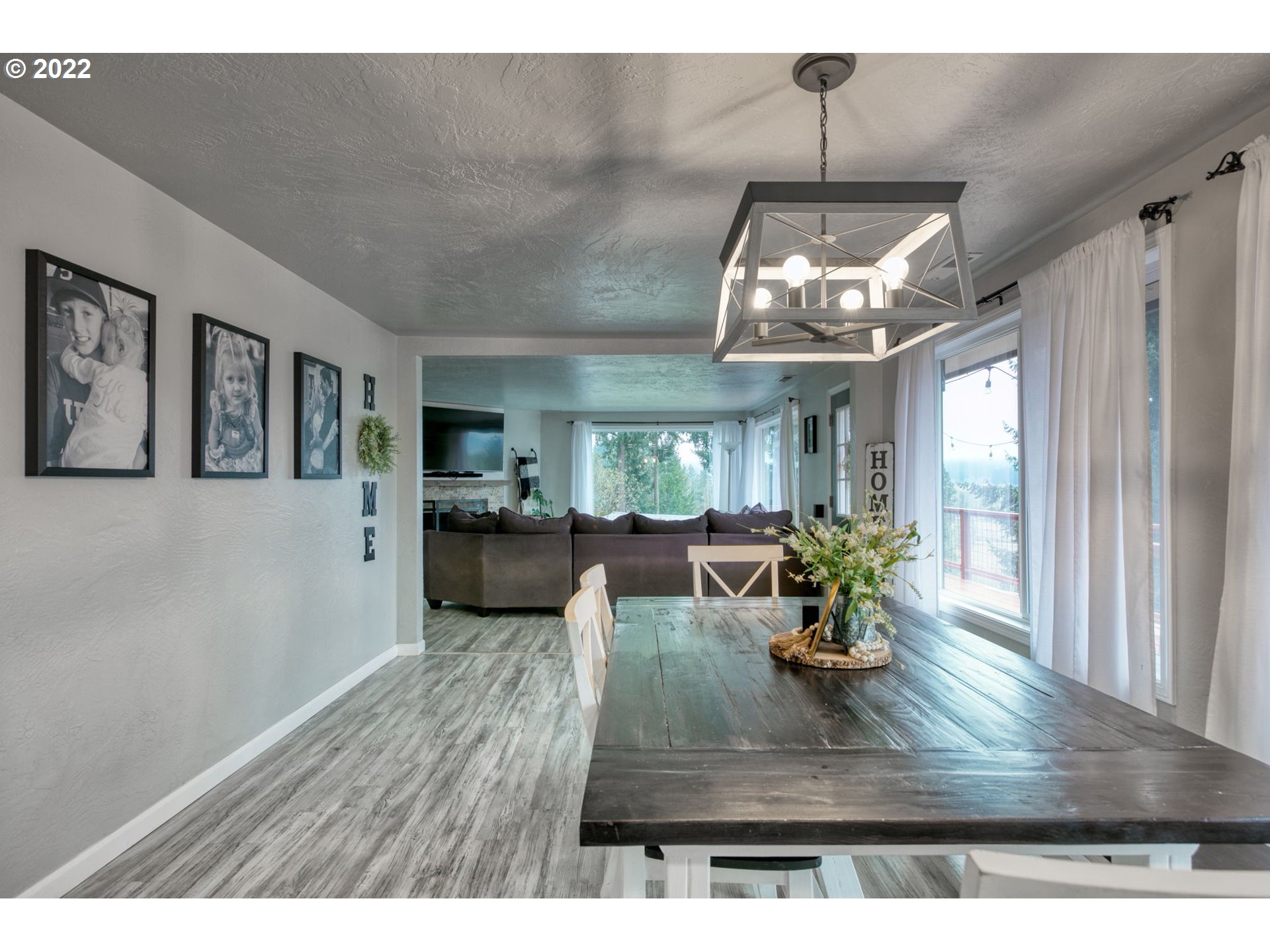 85903 Bailey Hill Road Eugene, OR 97405 - Photo 10 of 27 a view of a dining room with furniture large window and wooden floor