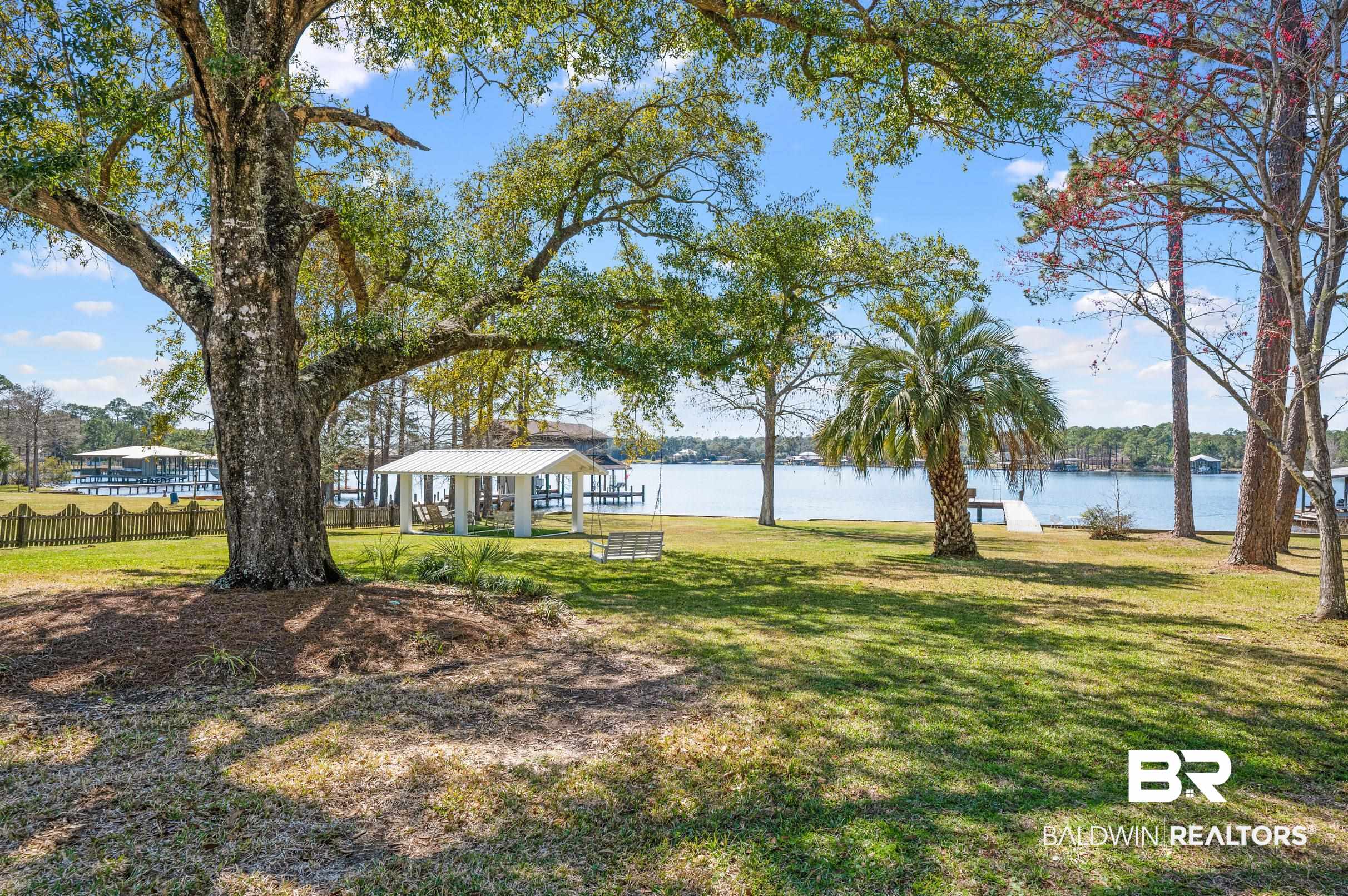 9459 Soldier Creek Road Lillian, AL 36549 - Photo 27 of 54 View of yard featuring a water view, fence, and a gazebo
