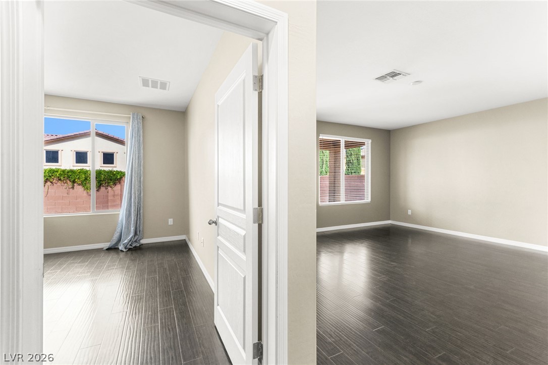 11048 Prairie Grove Road Las Vegas, NV 89179 - Photo 20 of 75 Hardwood floors stretch across two open rooms, ready for personalization.