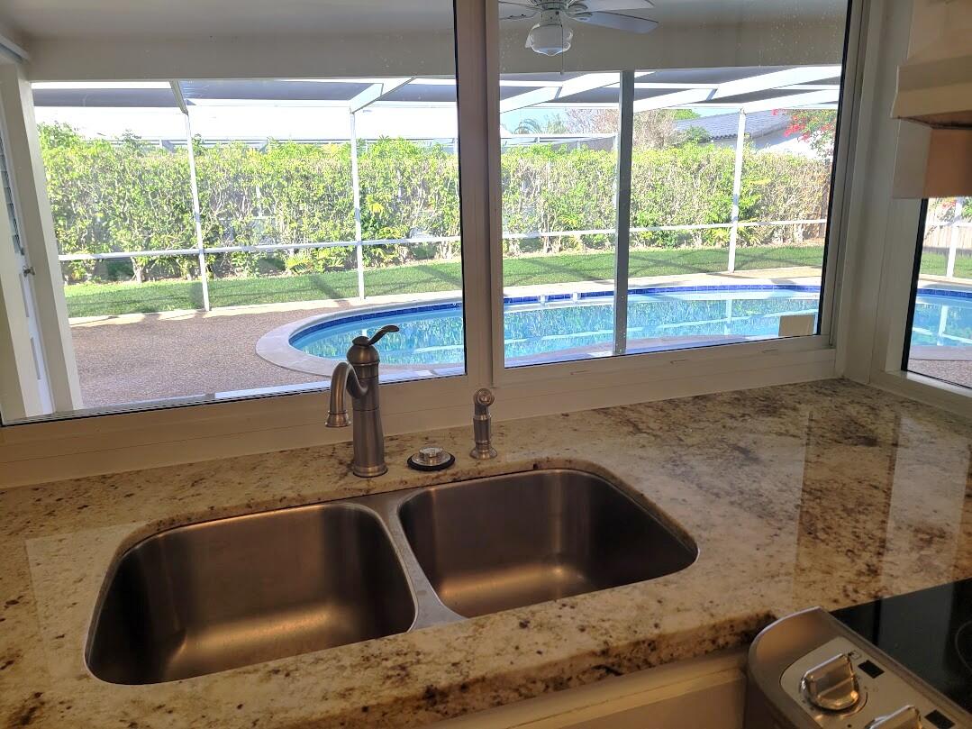 1927 Sharon Street Boca Raton, FL 33486 - Photo 11 of 23 20250128_153239 kitchen passthru window