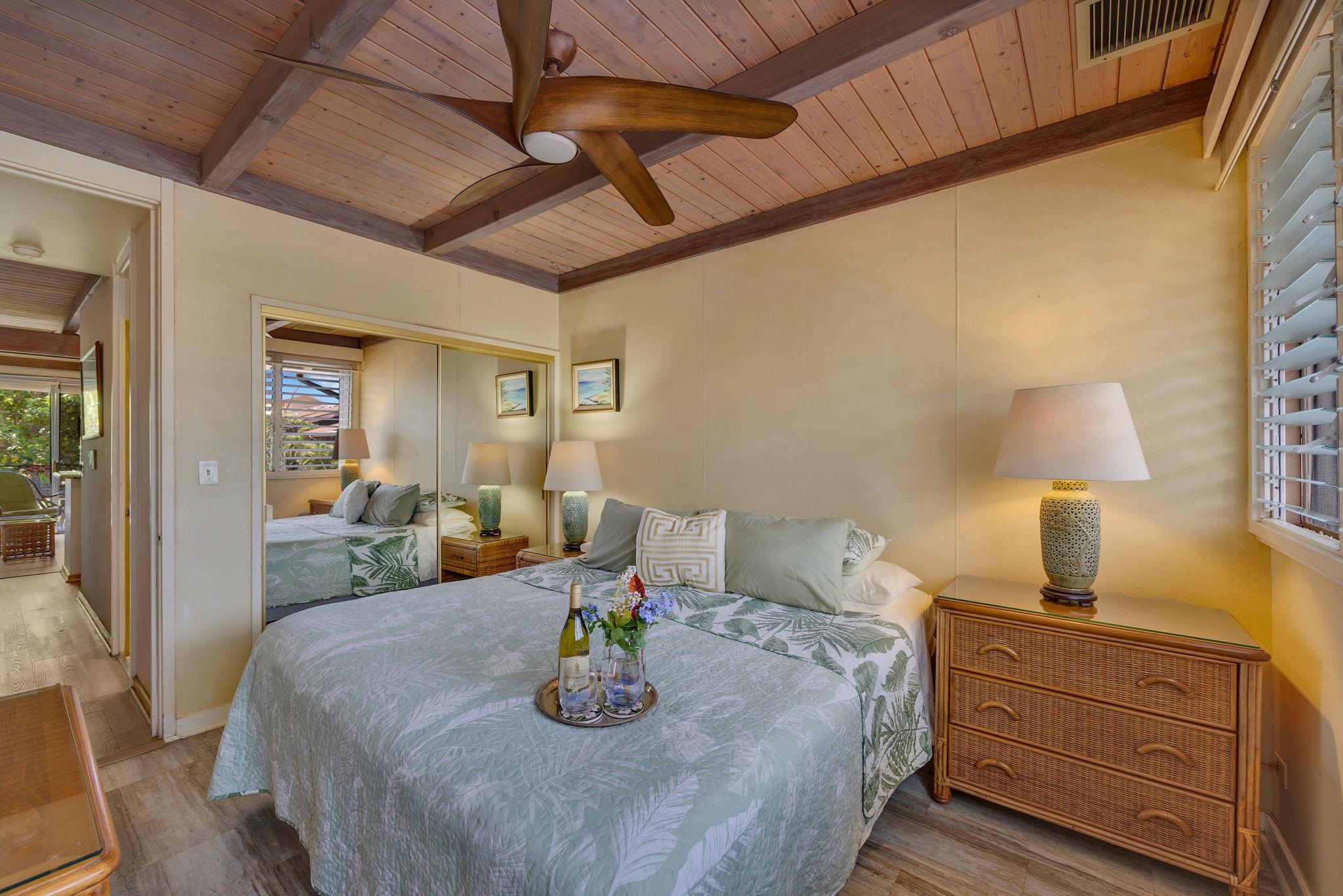 3691 Lower Honoapiilani Road, Unit 211 Lahaina, HI 96761 - Photo 16 of 47 a bed sitting in a bedroom next to a lamp