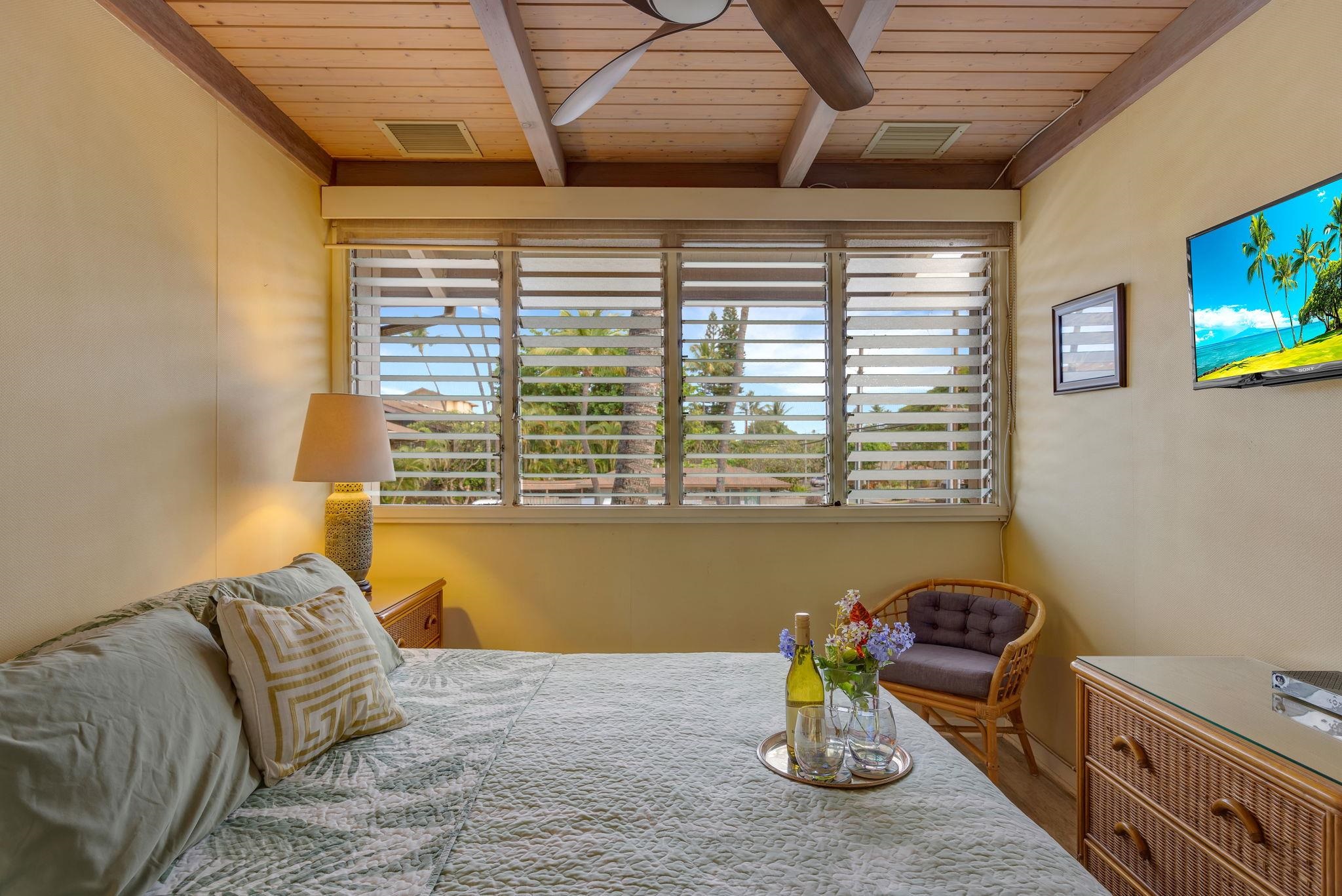 3691 Lower Honoapiilani Road, Unit 211 Lahaina, HI 96761 - Photo 17 of 47 a bed sitting in a bedroom next to a window