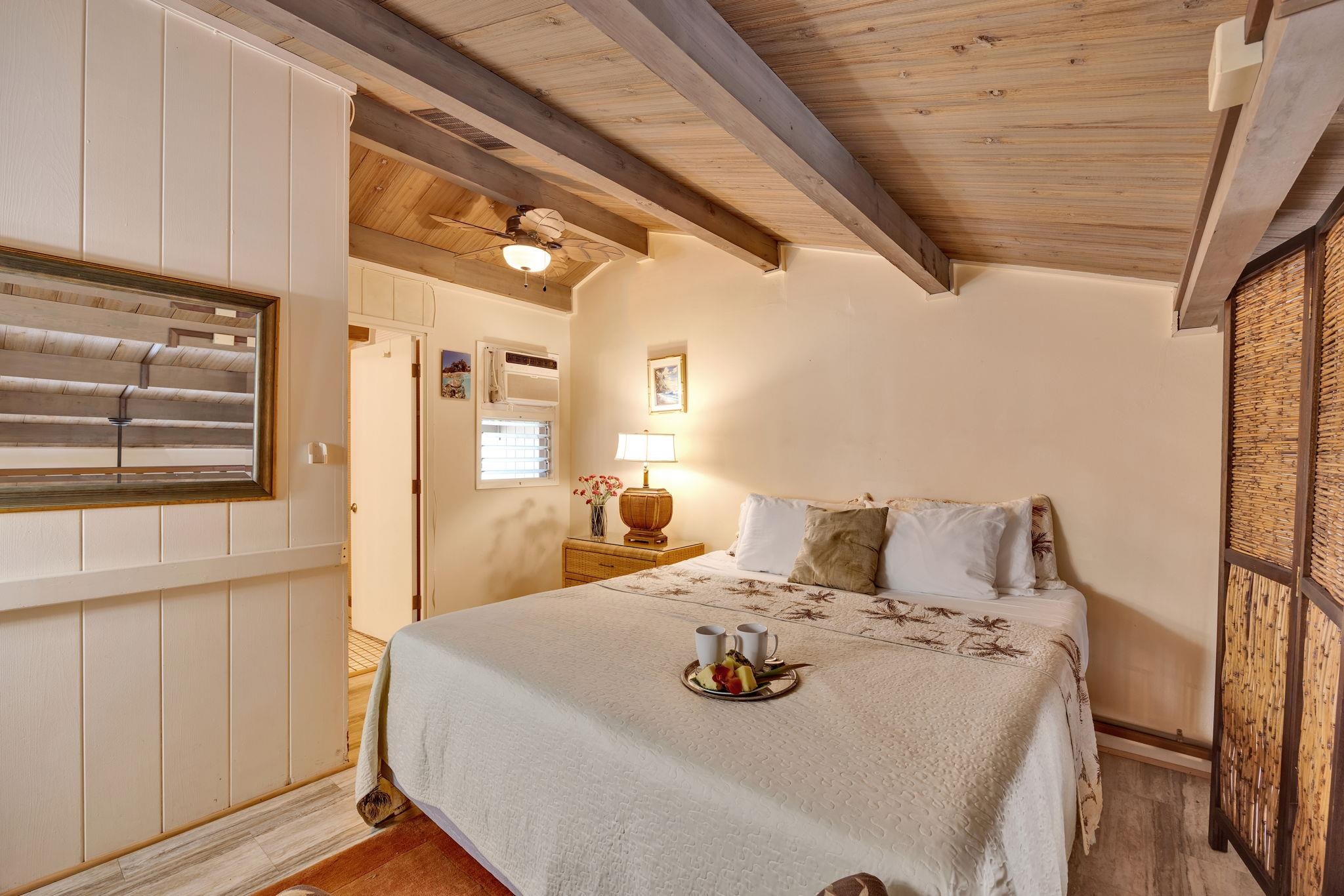 3691 Lower Honoapiilani Road, Unit 211 Lahaina, HI 96761 - Photo 20 of 47 a bedroom with a bed and window