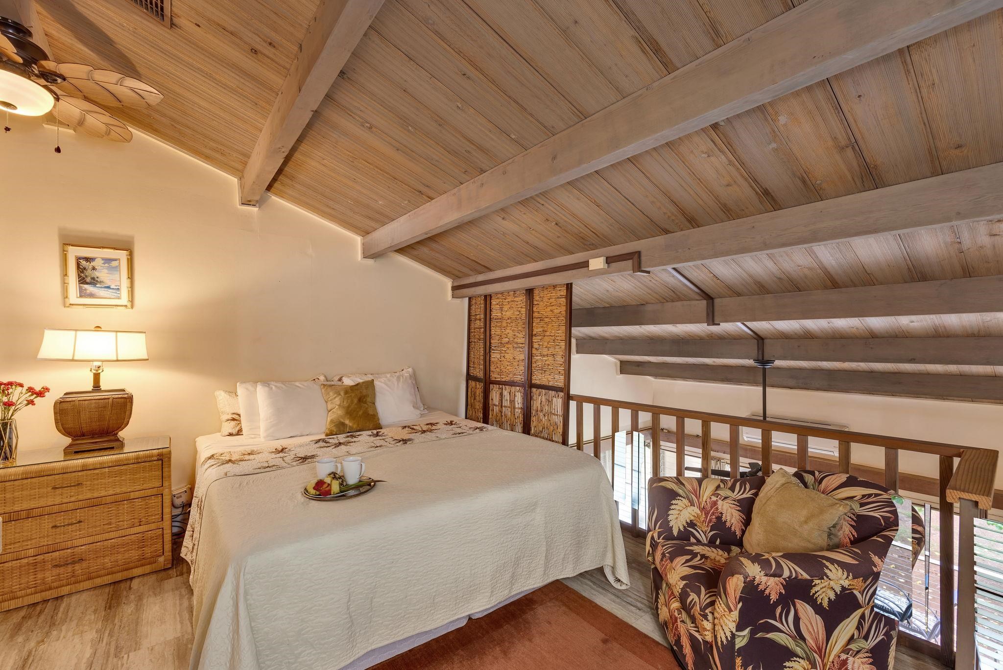 3691 Lower Honoapiilani Road, Unit 211 Lahaina, HI 96761 - Photo 21 of 47 a bedroom with furniture and wooden floor