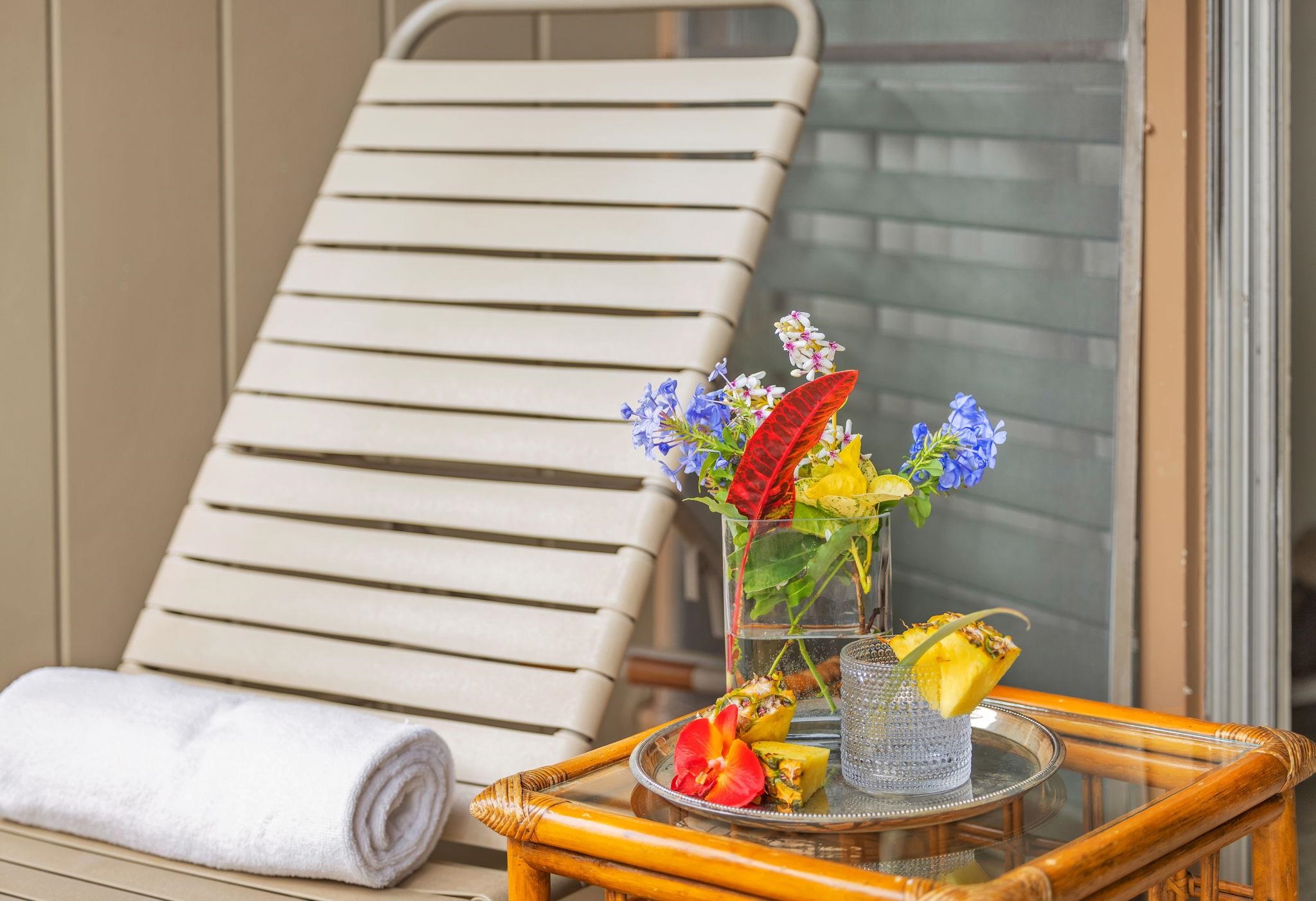 3691 Lower Honoapiilani Road, Unit 211 Lahaina, HI 96761 - Photo 31 of 47 a vase of flowers sitting on a table with a fireplace