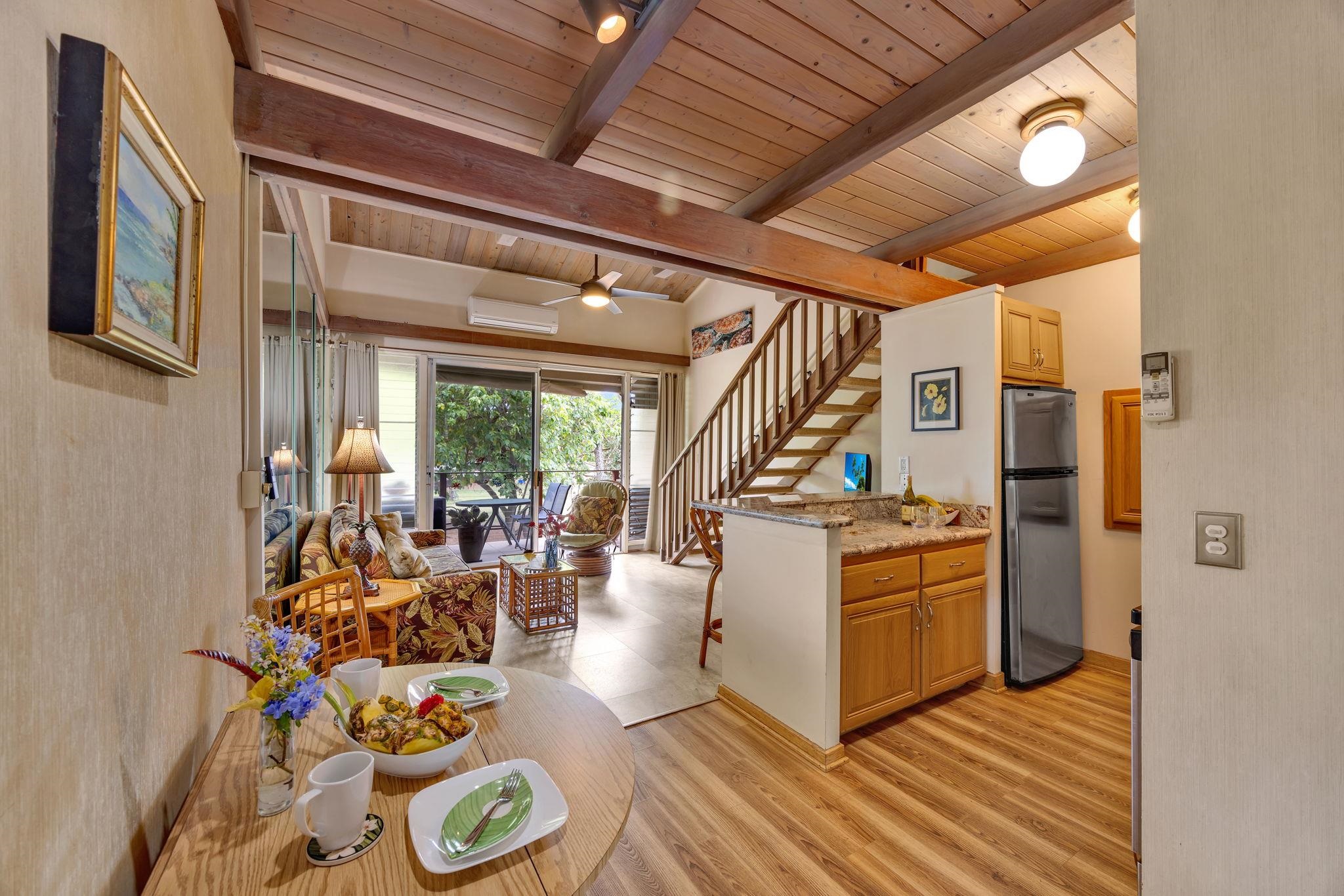 3691 Lower Honoapiilani Road, Unit 211 Lahaina, HI 96761 - Photo 5 of 47 a living room with furniture a fireplace and a table