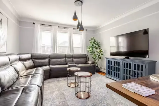 a living room with furniture wooden floor and window