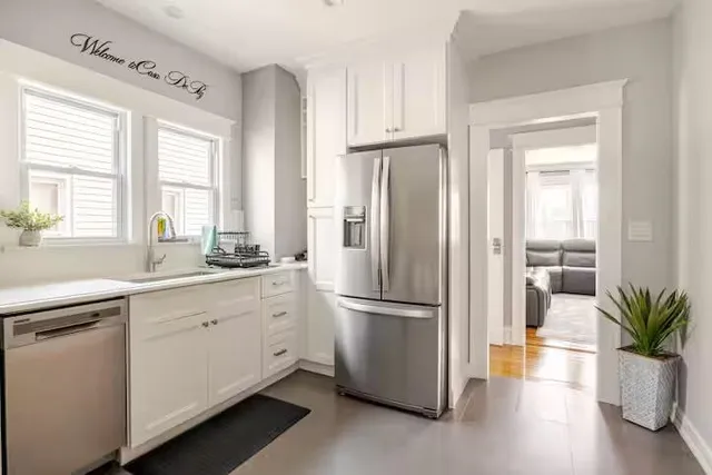 a kitchen with a refrigerator and a sink