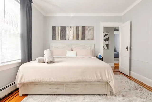 a bedroom with a bed and a window