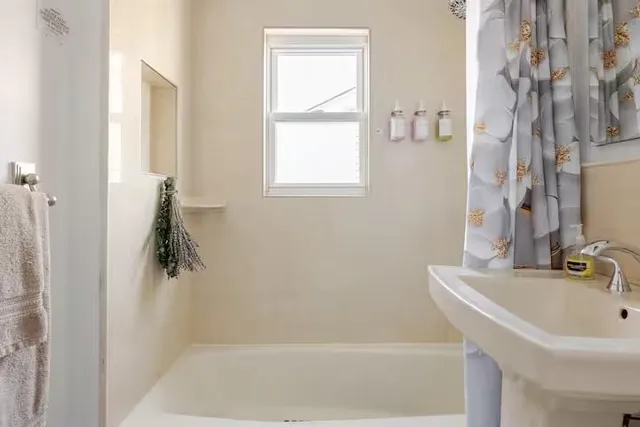 a bathroom with a bathtub and shower