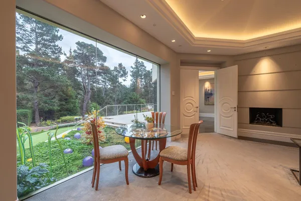 a dining room with furniture and garden view