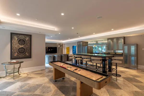 a living room with furniture a flat screen tv and kitchen view