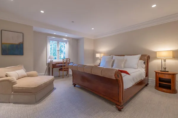 a spacious bedroom with a bed and glass windows