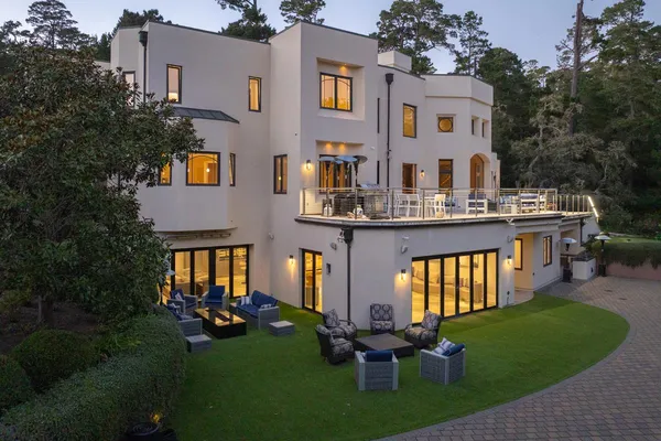 a front view of a house with garden and patio