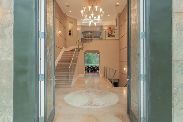 a view of a livingroom with a flesh screen tv and front door