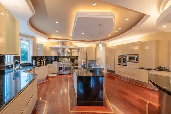 a room with stainless steel appliances lots of counter space and furniture