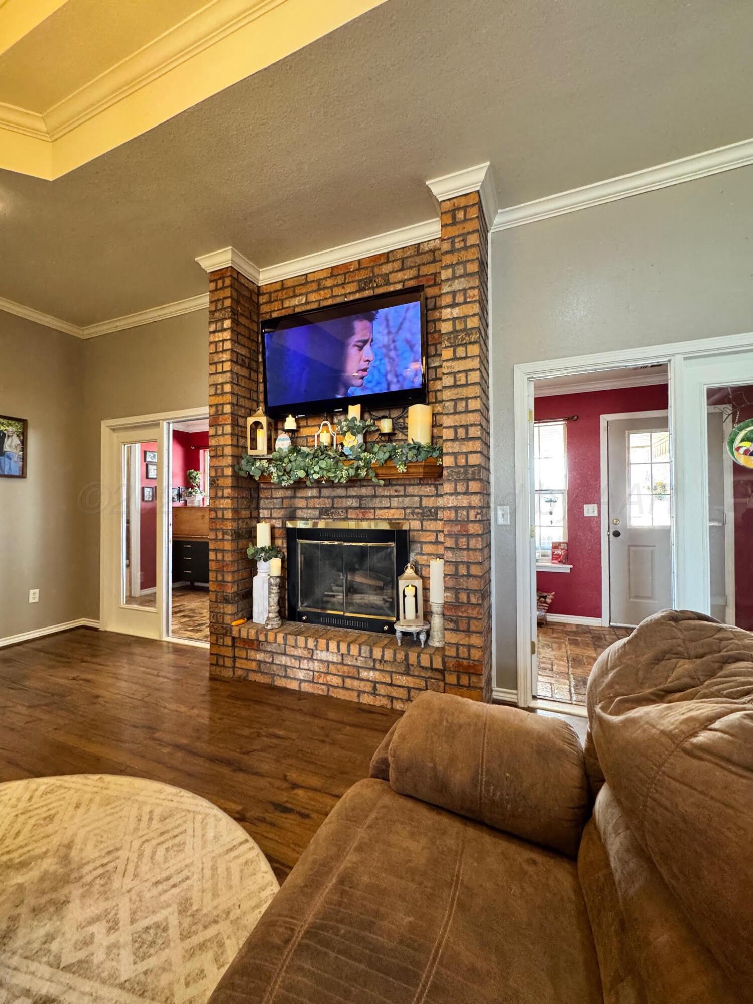 200 Hunters Trail Bushland, TX 79124 - Photo 4 of 23 a living room with furniture a flat screen tv and a fireplace