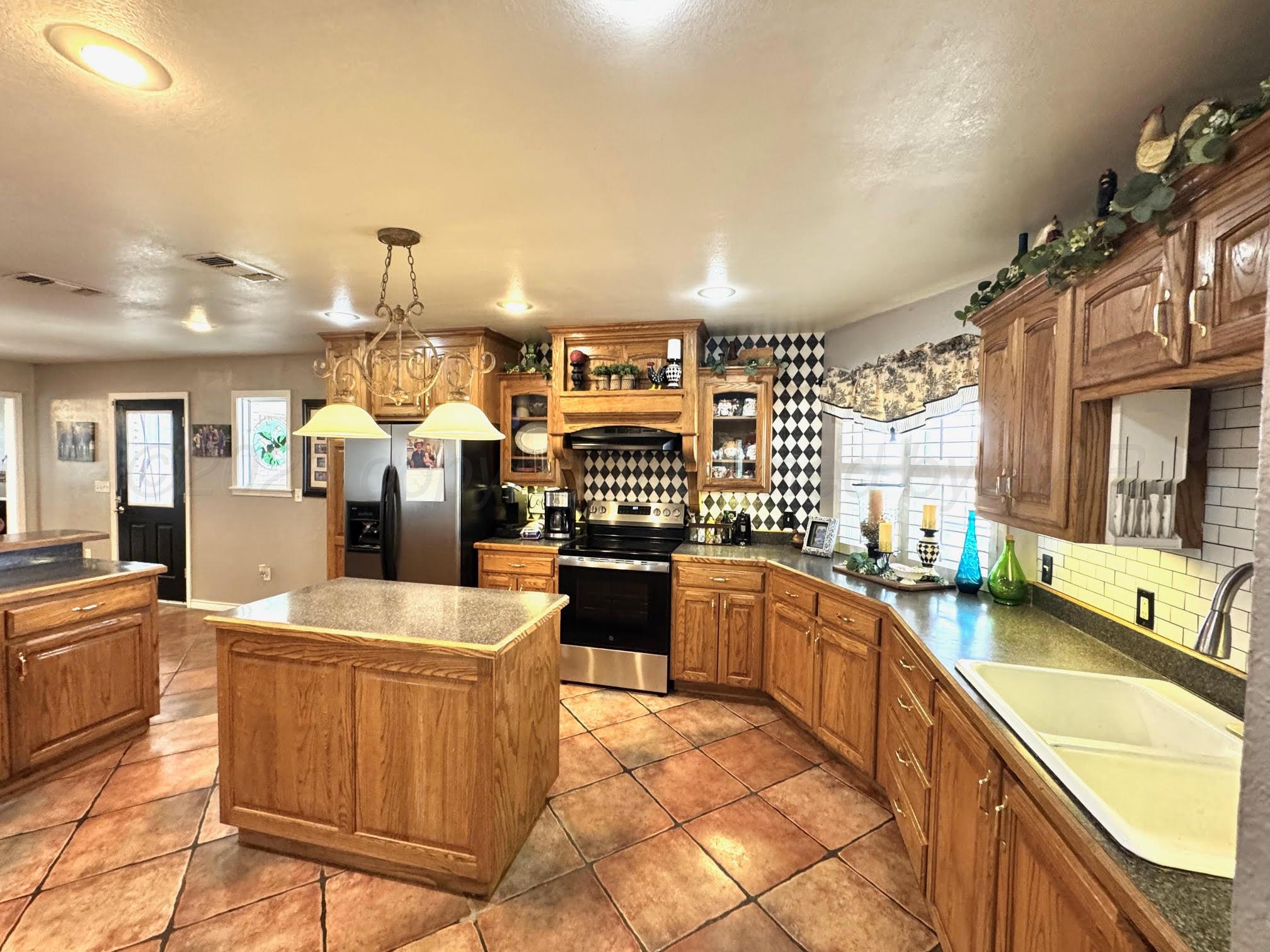 200 Hunters Trail Bushland, TX 79124 - Photo 6 of 23 a large kitchen with stainless steel appliances kitchen island granite countertop a sink and cabinets