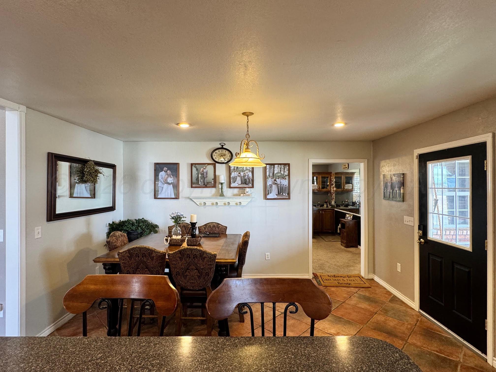 200 Hunters Trail Bushland, TX 79124 - Photo 8 of 23 a living room with furniture a chandelier and a window