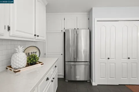 a kitchen with kitchen island a counter space and cabinets