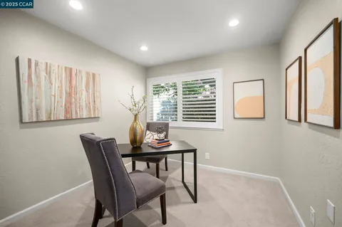 a view of a dining room with furniture and a window