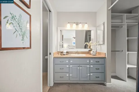 a bathroom with a granite countertop sink a large mirror and a bathtub