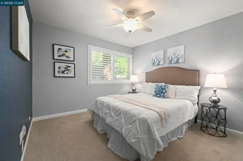 a bedroom with a bed and a lamp