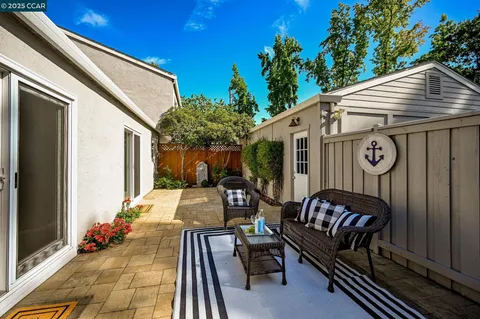 a view of a patio with table and chairs and potted plants