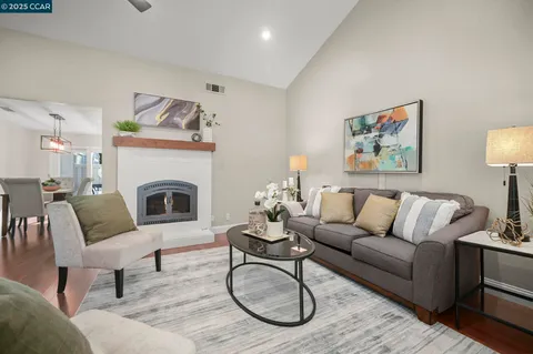 a living room with furniture a rug and a fireplace