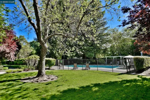 a swimming pool with outdoor seating and yard