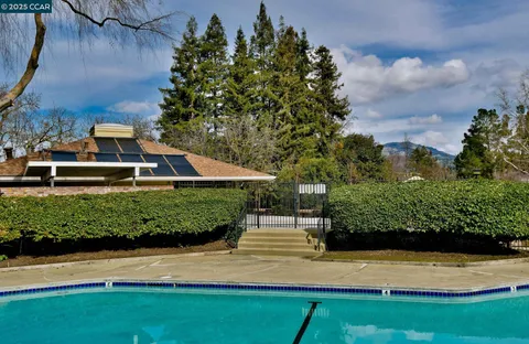 a view of backyard with outdoor seating and green space