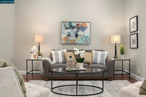 a living room with furniture and a lamp