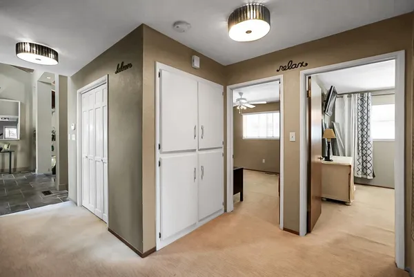 a view of a hallway with wooden shelves